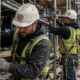 Construction workers on busy scaffold site