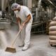 Industrial worker cleaning in processing plant