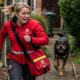 Postal worker fleeing from angry dog